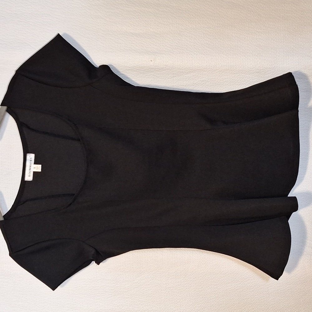 Black small blouse with ruffle bottom.